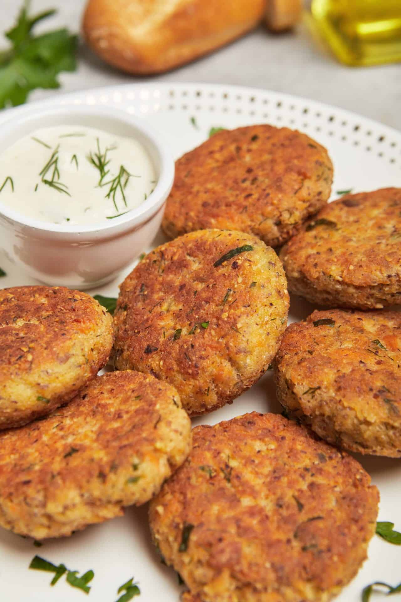 Crispy homemade crab cakes with a side of herbed sour cream sauce. Perfect appetizer or main dish for seafood lovers.