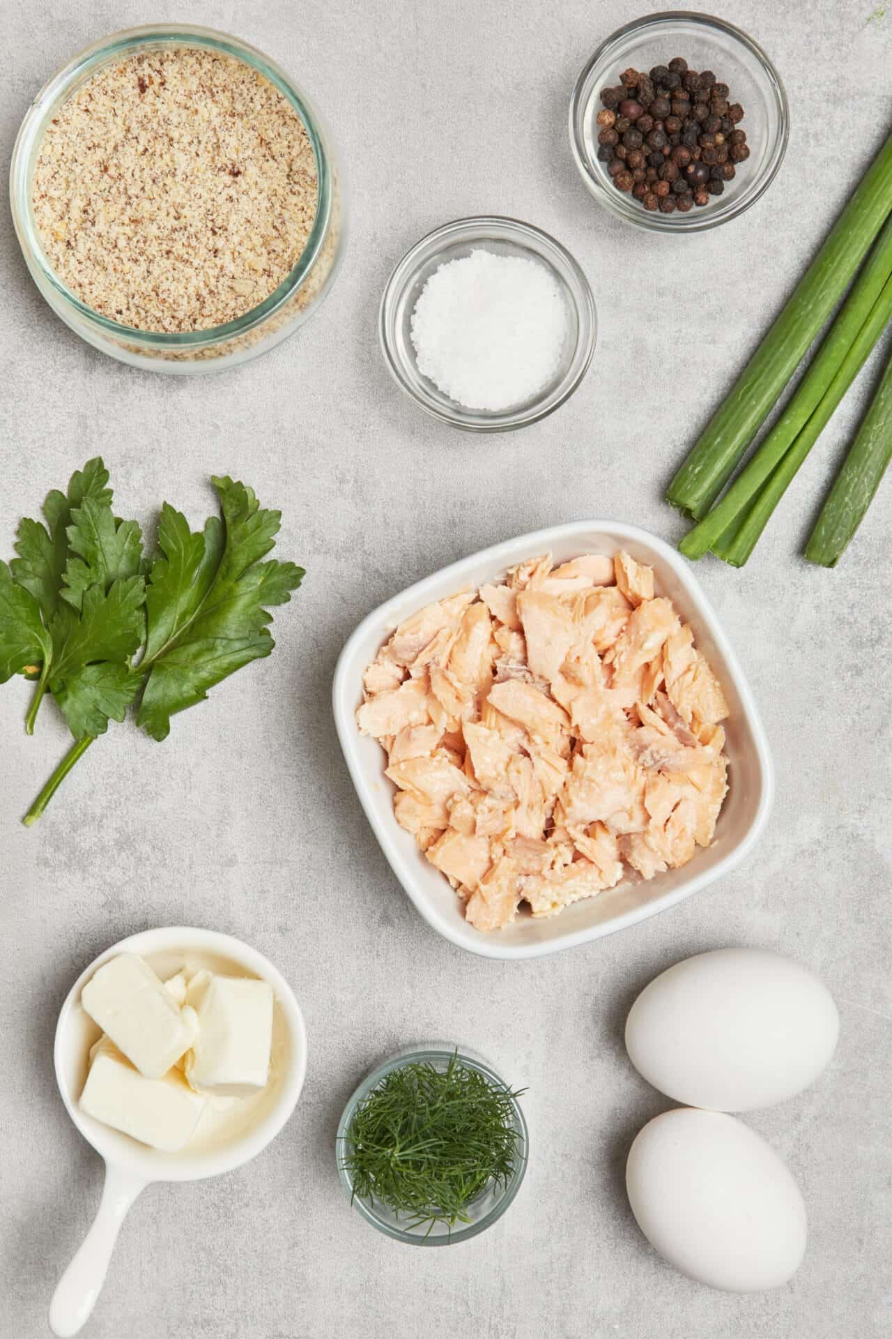 Cooked chicken, eggs, and fresh herbs for a savory baked dish.