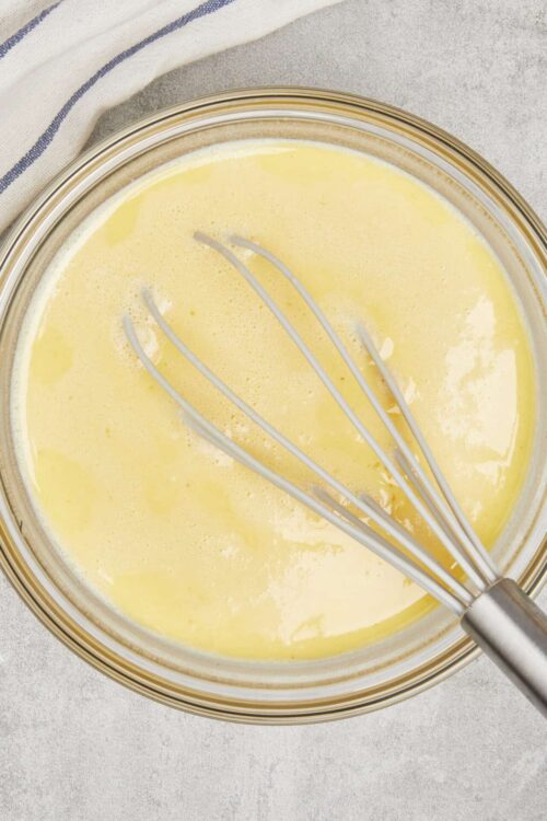 Butter mixture for baking, yellow melted butter and eggs in glass bowl, baking ingredients, whisk in bowl, Baked Bree recipe ingredient, food photography.