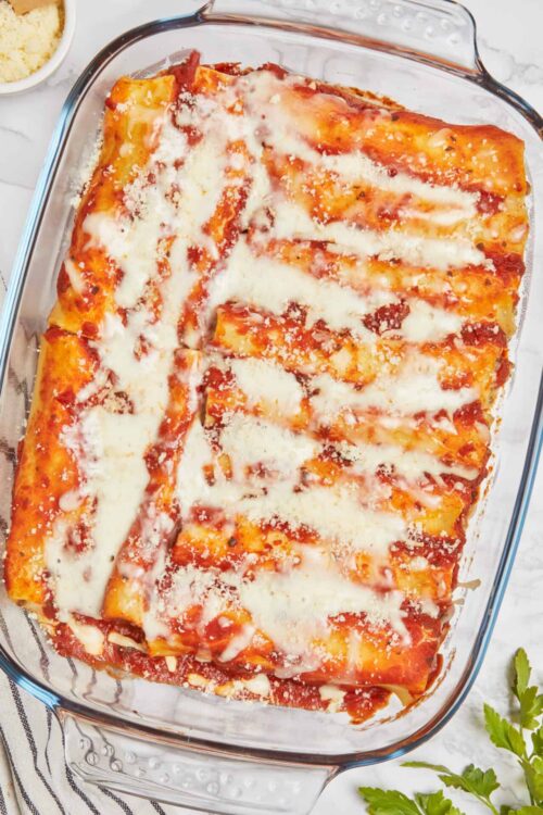 Savory homemade lasagna in a glass dish with melted cheese and tomato sauce.