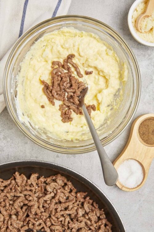 Creamy mashed potatoes with cooked ground beef and seasonings for delicious comfort food.