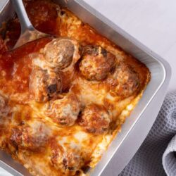 Savory meatloaf with tomato sauce in baking pan.