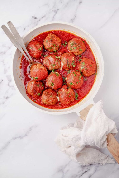 Savory Italian meatballs in marinara sauce garnished with fresh herbs. Perfect for comfort food and family dinners.