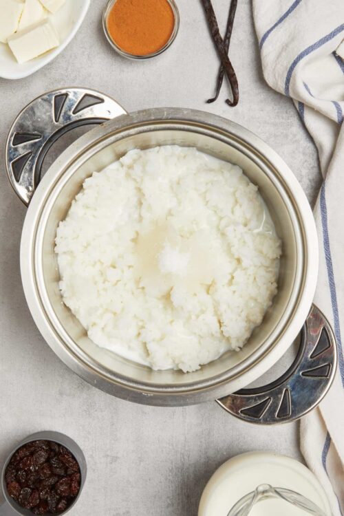 Cream cheese and butter mixture for cheesecake filling, surrounded by baking ingredients.