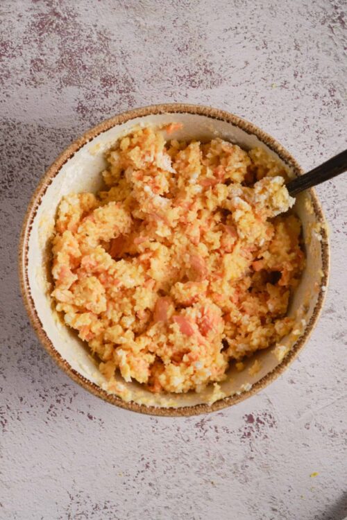 Creamy homemade mashed sweet potatoes with a hint of orange color, served in a rustic bowl.
