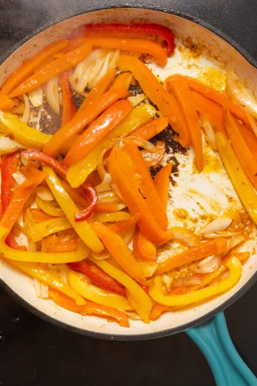 Colorful sautéed bell peppers and onions in a skillet, perfect for healthy recipes and easy vegetable dishes.