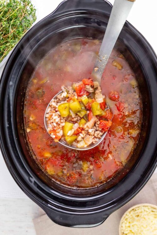 Hearty vegetable and ground beef stew in slow cooker, ready to serve. Perfect comfort food for chilly days or family dinners.