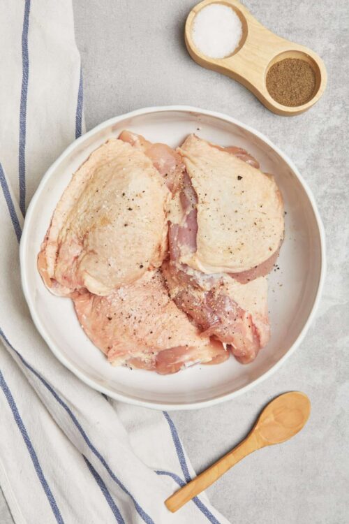 Raw chicken thighs ready for seasoning and cooking.