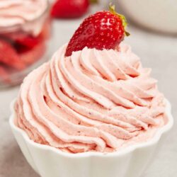 Fresh strawberry whipped cream in a white bowl, perfect for desserts and baking.
