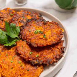 Crispy tawa potato pancakes with herbs and spices, close-up photograph.