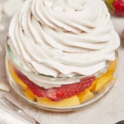 Fresh strawberry shortcake dessert with whipped cream and vibrant fruit layers.