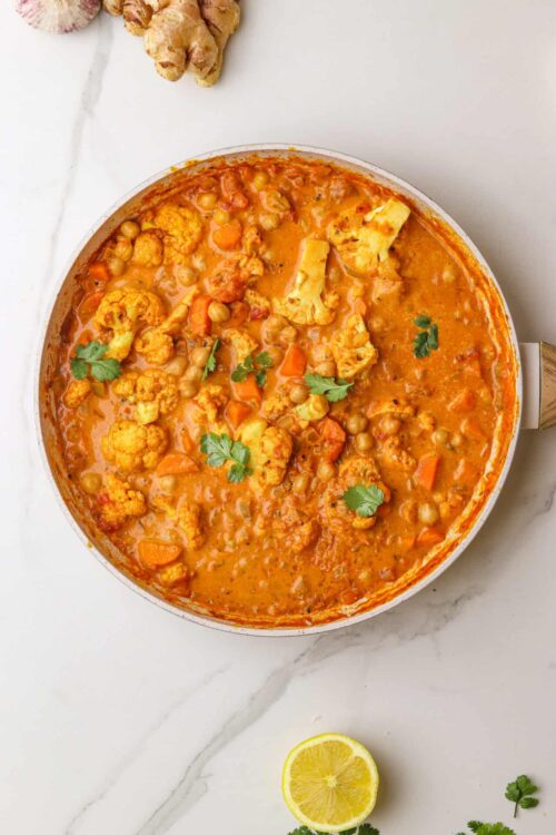 Hearty vegetable curry with cauliflower, chickpeas, and carrots in a flavorful tomato sauce.