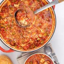 Hearty homemade chicken and sausage gumbo in a large red Dutch oven.
