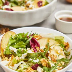 Fresh vegetable salad with pears, walnuts, feta cheese, and mixed greens.