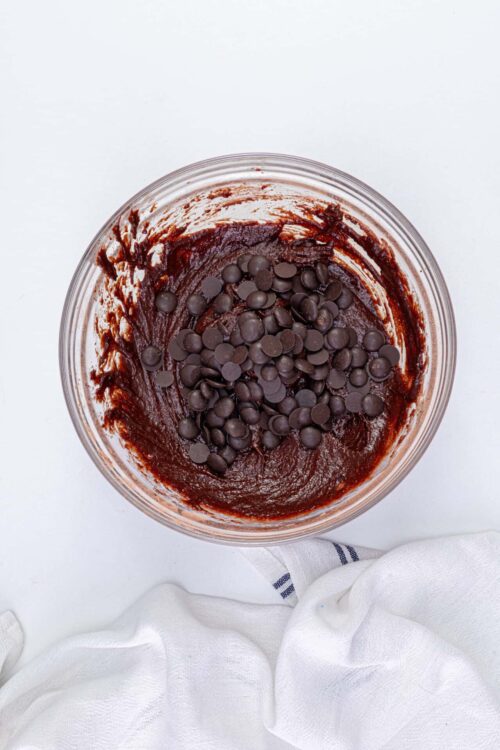 Rich chocolate cake batter with chocolate chips for baking or dessert recipes.