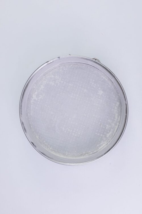 Fine mesh sieve for baking and flour sifting on a white background.
