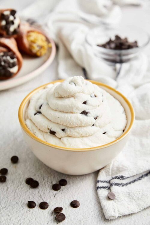 Cream cheese chocolate chip frosting in a bowl, perfect for baking and sweet desserts.