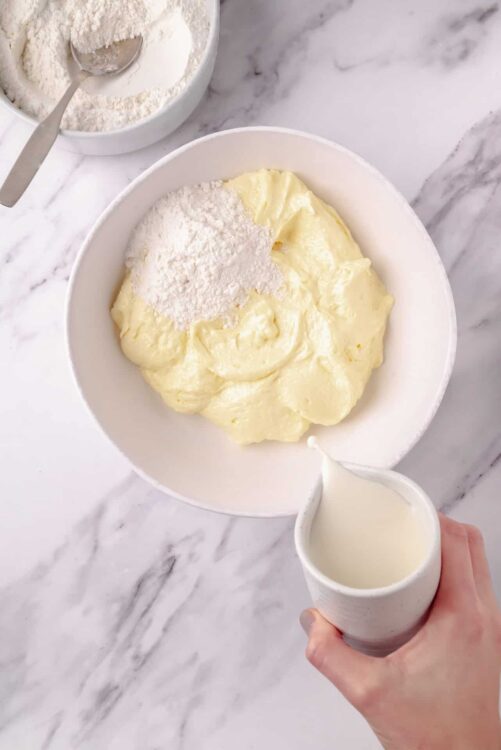 Creamy butter mixture with flour, preparing for baking or making pastries.