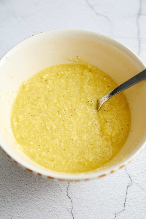 Creamy melted butter with black pepper in a mixing bowl.
