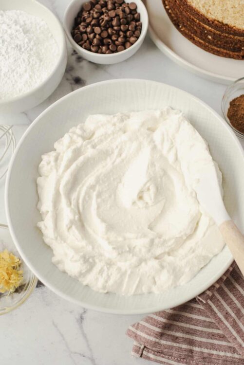 Fluffy whipped cream mixture in a white bowl, ready for baking or dessert topping.