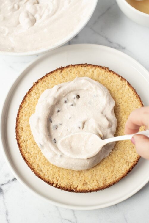 Butter cake with homemade chocolate frosting being spread, baked goods, frosting, dessert, baking, cake decorating, homemade cake, bakery, sweet treat, dessert recipe.