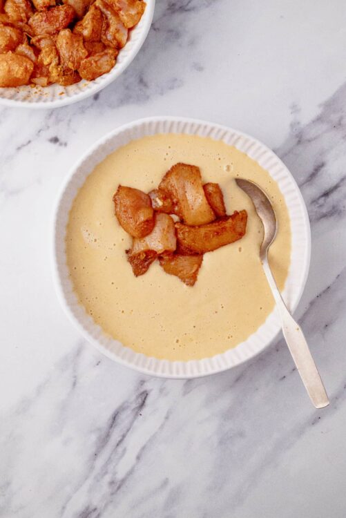 Creamy apple cobbler soup served in a white bowl with caramelized apple topping, perfect for fall desserts.