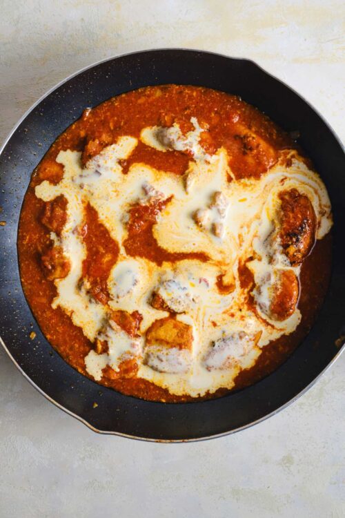 Savory chicken and tomato cheese casserole with melted cheese and a flavorful sauce.