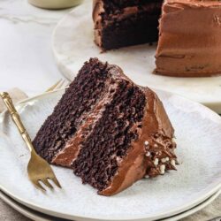 Decadent chocolate cake with rich frosting and layered interior, perfect for celebrations and desserts.