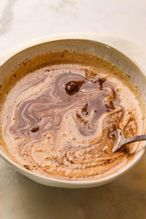 Rich homemade hot chocolate with swirling chocolate and creamy milk.