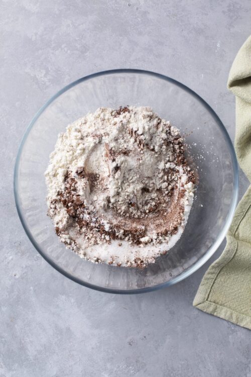 Flour, cocoa powder, and sugar mixture in a glass bowl for baking.