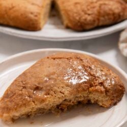 Fried apple hand pie on a white plate with a golden brown crust.