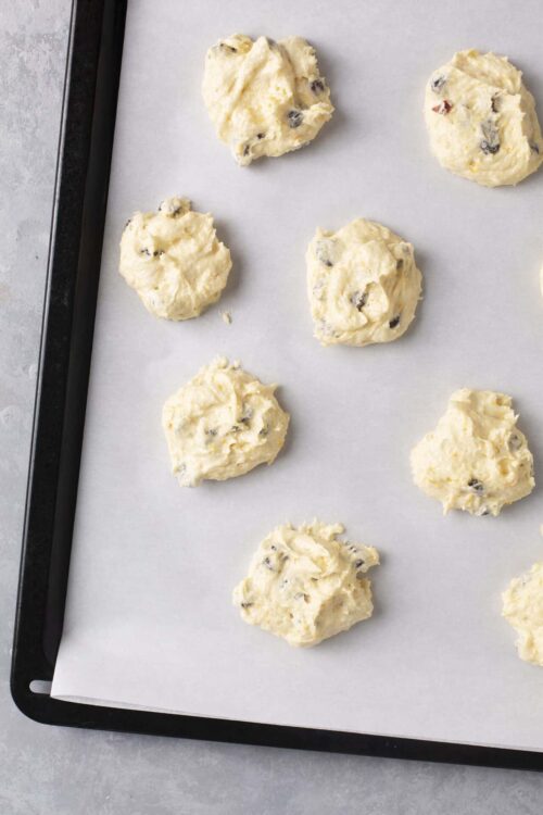 Buttery chocolate chip cookie dough on baking sheet, ready to bake, sweet homemade cookies, bakery style cookie dough preparation, bakedbree.com.