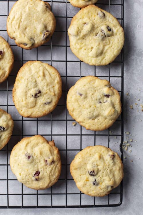 Buttery chocolate chip cookies cooling on a wire rack fresh out of the oven.