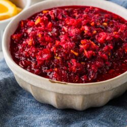 Sweet homemade cranberry sauce served in a rustic bowl, perfect for holiday desserts.