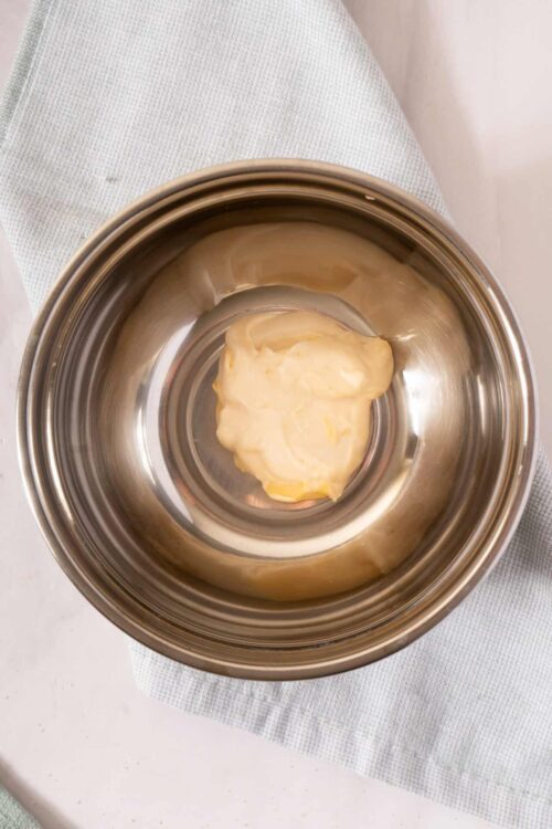 Butter in stainless steel mixing bowl.