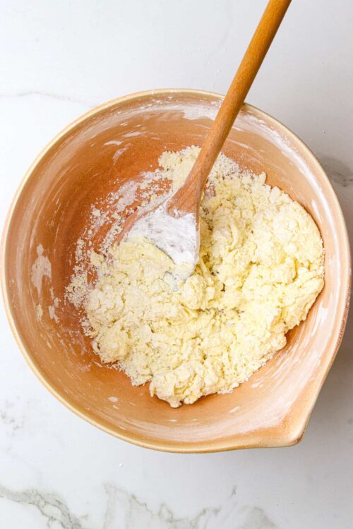 Butter and flour mixture in a mixing bowl with a wooden spoon, baking ingredients for homemade pastry, baking recipe preparation, Baked Bree.