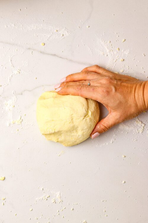 Soft buttery dough ready for baking, on a clean surface with flour dust.