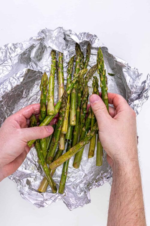 Fresh roasted asparagus wrapped in aluminum foil.