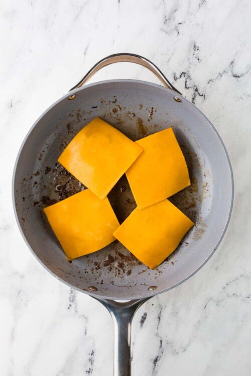 Creamy butternut squash in a skillet for roasted vegetable recipe.
