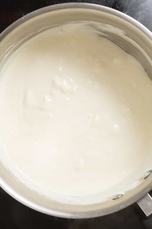 Creamy white sauce in a saucepan.