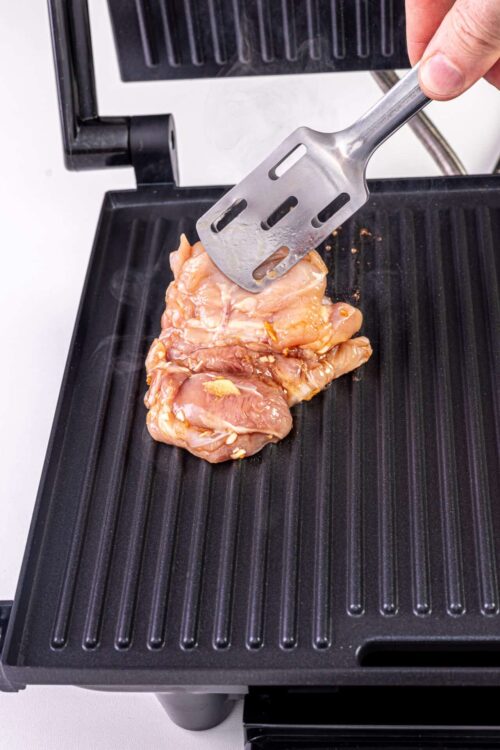 Juicy marinated chicken on a grill pan for healthy cooking.