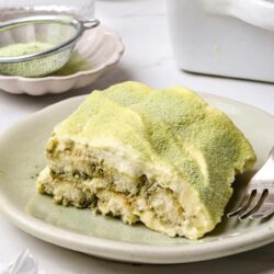 Creamy pistachio dessert with a crumbly texture on a white plate.