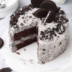 Rich chocolate cookies and cream cake with Oreo toppings, perfect for dessert lovers.