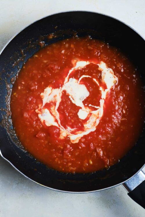 Rich tomato sauce with cream swirl for baked pasta or pizza.