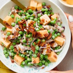 Crispy bacon, fresh peas, and cheddar cheese in a creamy salad.
