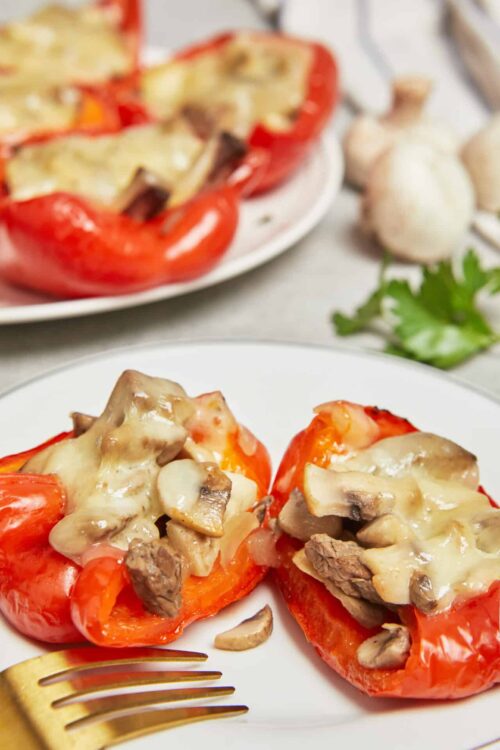Roasted stuffed bell peppers with cheese and mushrooms, baked to perfection for a delicious meal.