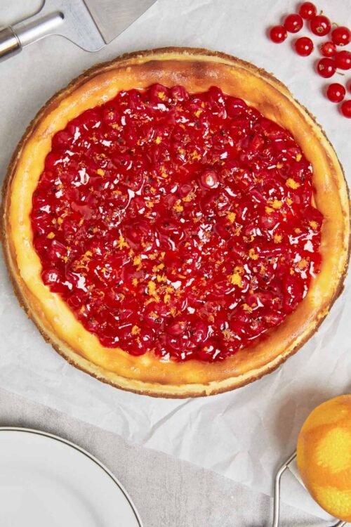 Fresh cherry cheesecake with a golden crust and vibrant red cherry topping. Perfect for summer dessert recipes.