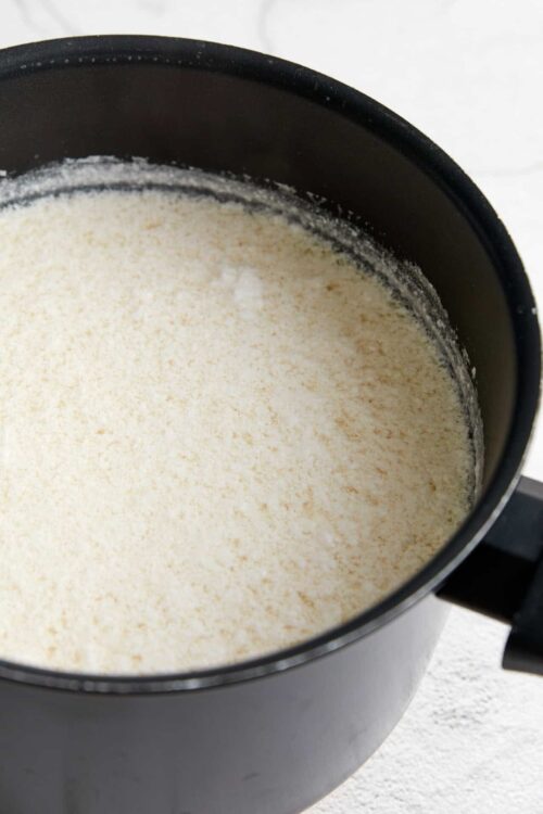 Powdered panko bread crumbs in a black spice jar for baked recipes and crispy coatings.