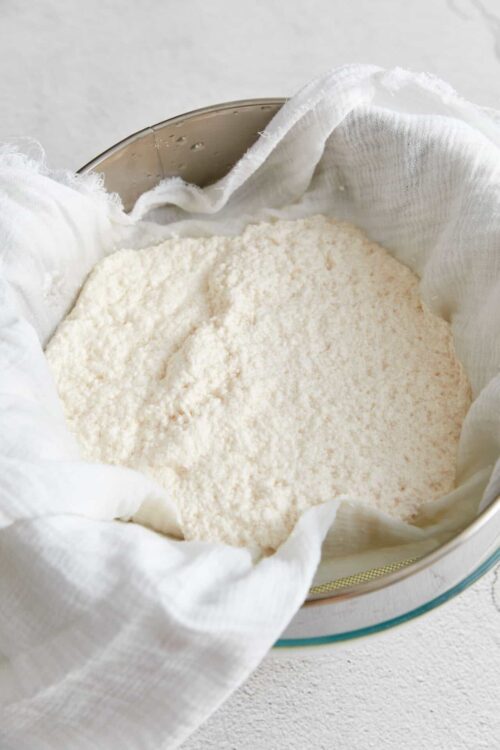 Finely sifted all-purpose flour in a white cheesecloth-lined bowl.