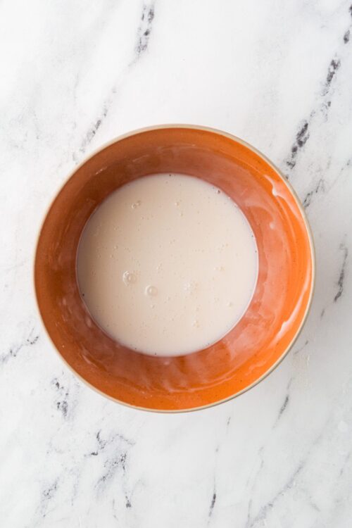 Cream in a terracotta bowl for baking or cooking.